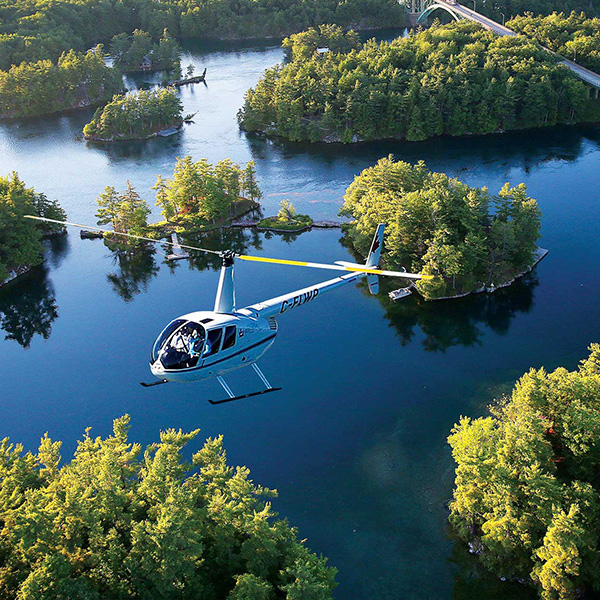 A helicopter flies over the St. Lawrence River.