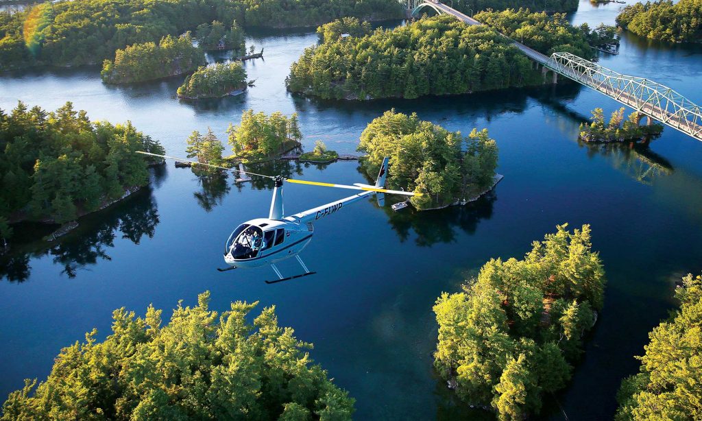 A helicopter soars above the 1000 Islands