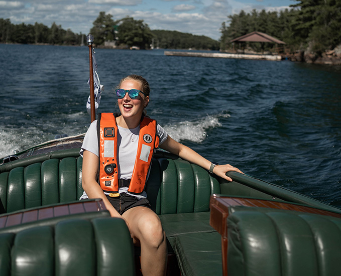 A person in a historic wooden boat in the 1000 Islands