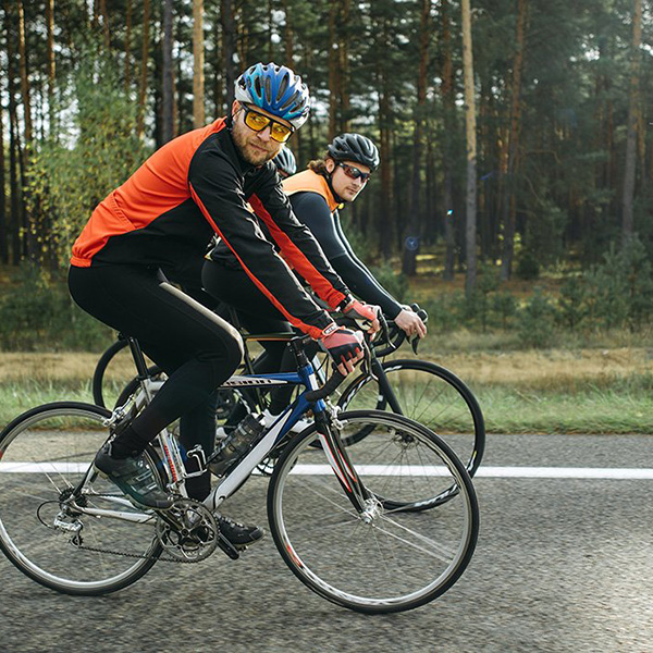 Two bikers travelling down a highway