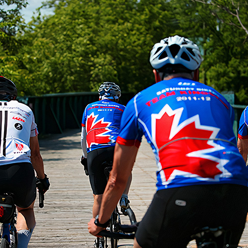 Three cyclists on a boardwalk.