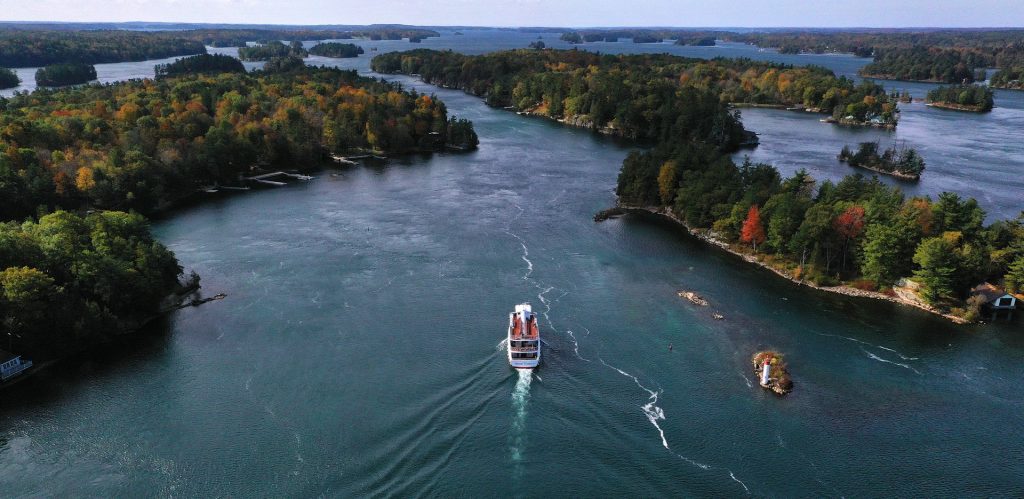 A tour boat makes its way through the St. Lawrence River.