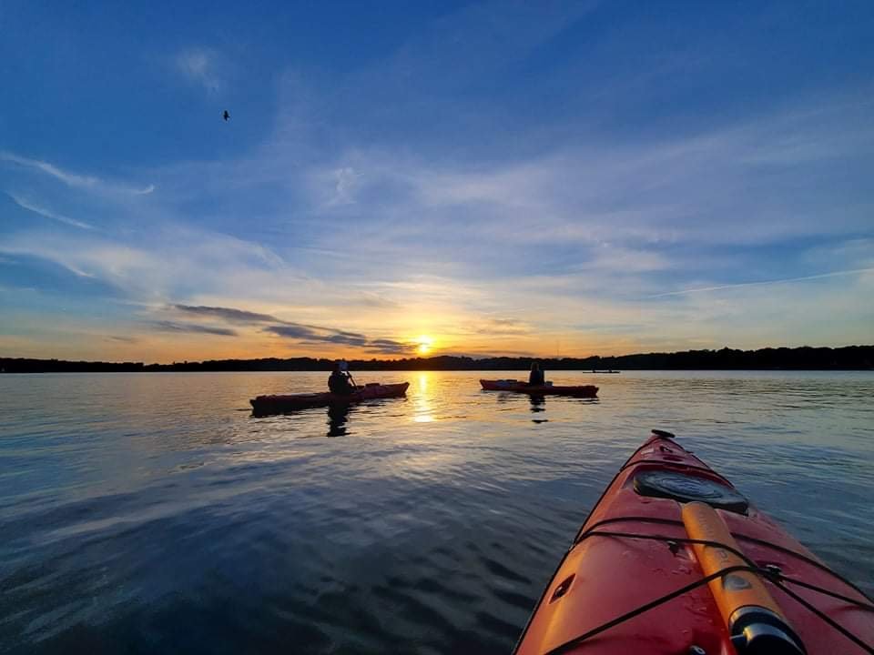 Three kayaks at sunset in the St. Lawrence River.