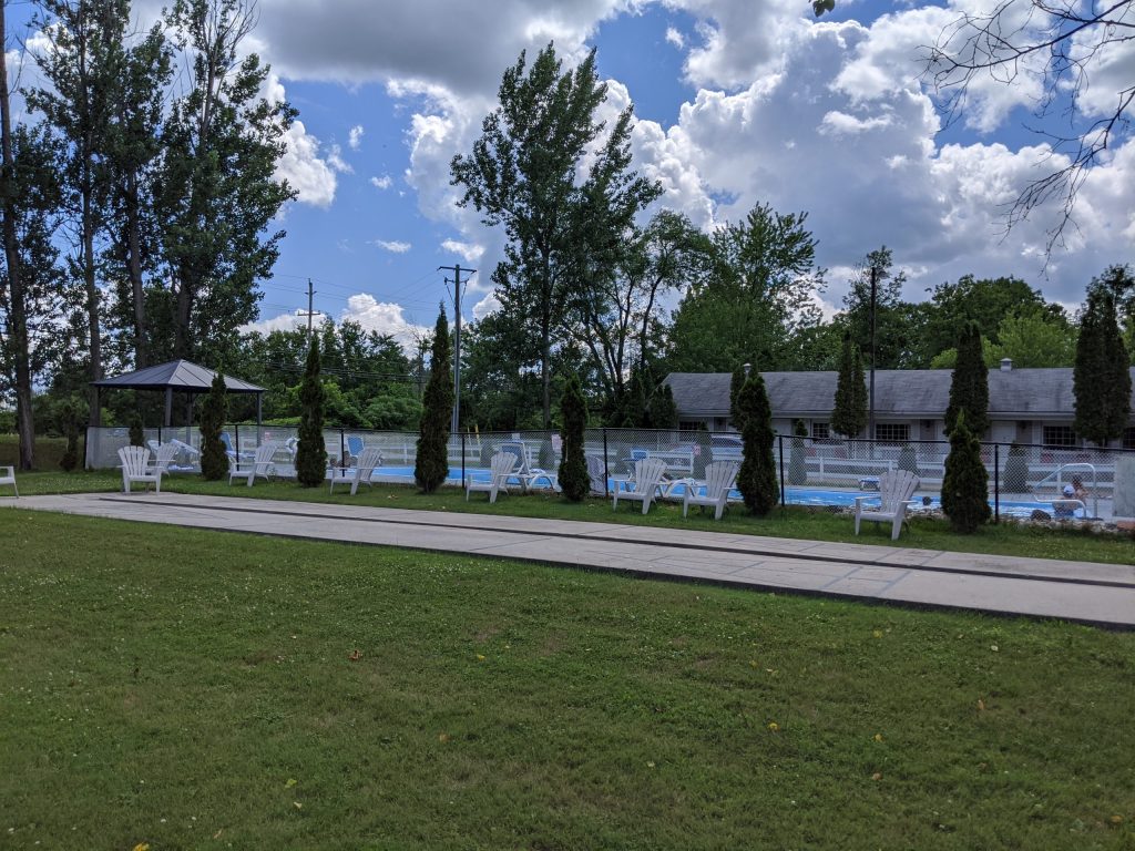 An outdoor pool surrounded by grass. 