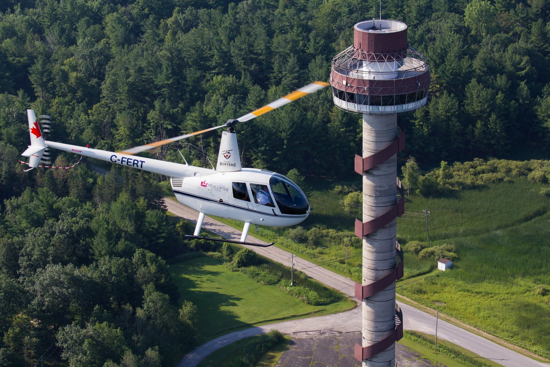 A helicopter soars above the 1000 Islands Tower.