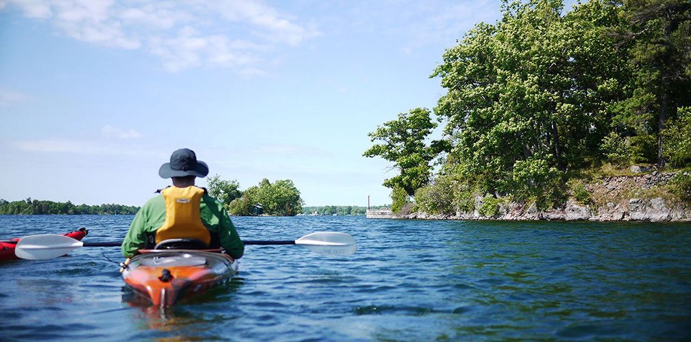 A group of people kayaking in the 1000 Islands.