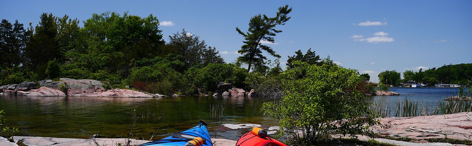 Two kayaks on the banks of the St. Lawrence River. 