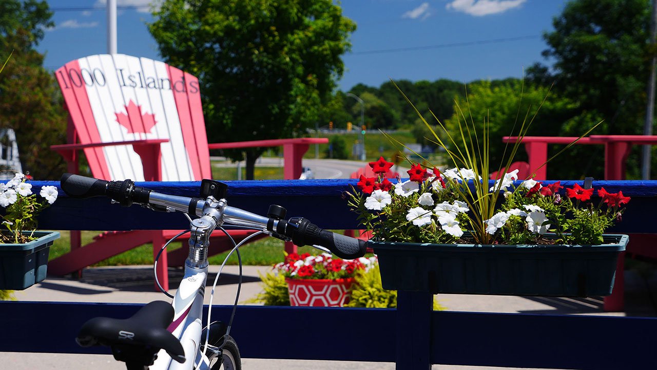 A bike with a red and white chair in the background.