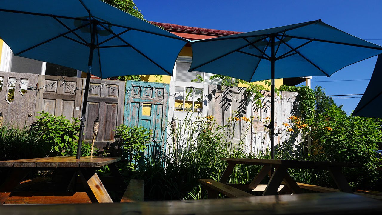 A patio with two umbrellas.