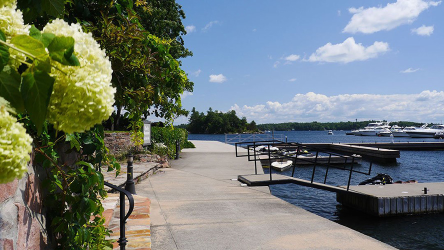 A sidewalk winds along a riverbank.