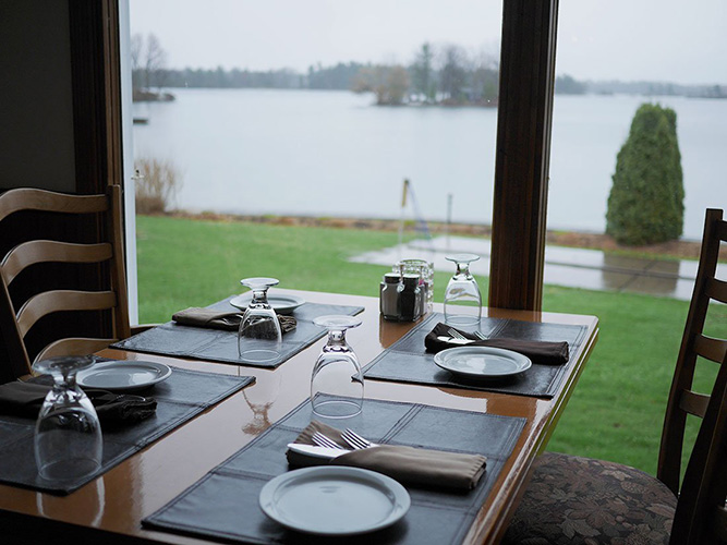 Plates sit on a table in front of a window.