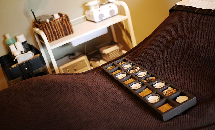 A massage bed with candles.