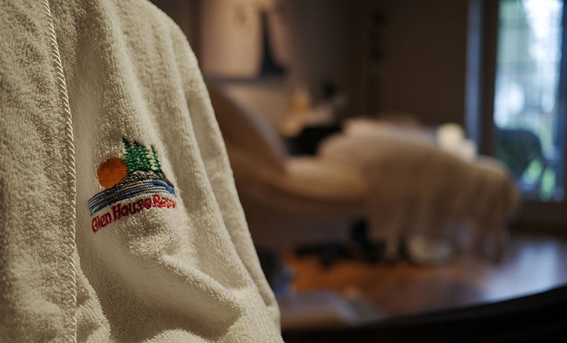 A terry cloth robe with the Glen House Resort logo.