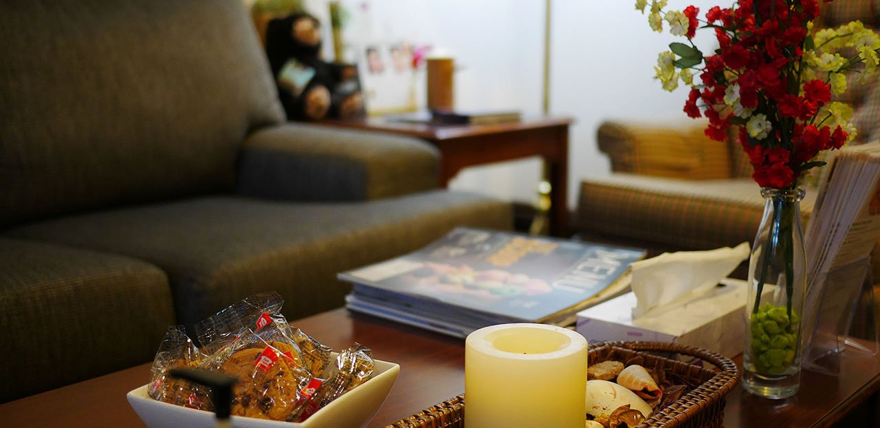 A table with a candle and flowers.