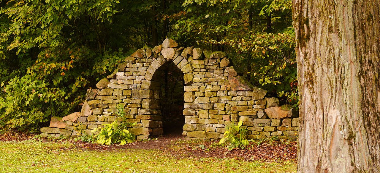 A doorway in the middle of an ancient stone wall.