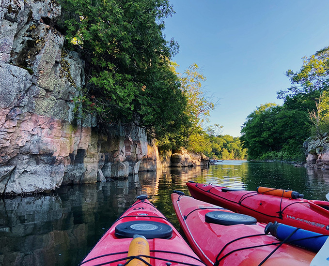 Three red kayaks in the St. Lawrence River