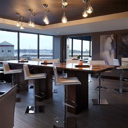 A modern restaurant with high-top tables and bar stools.